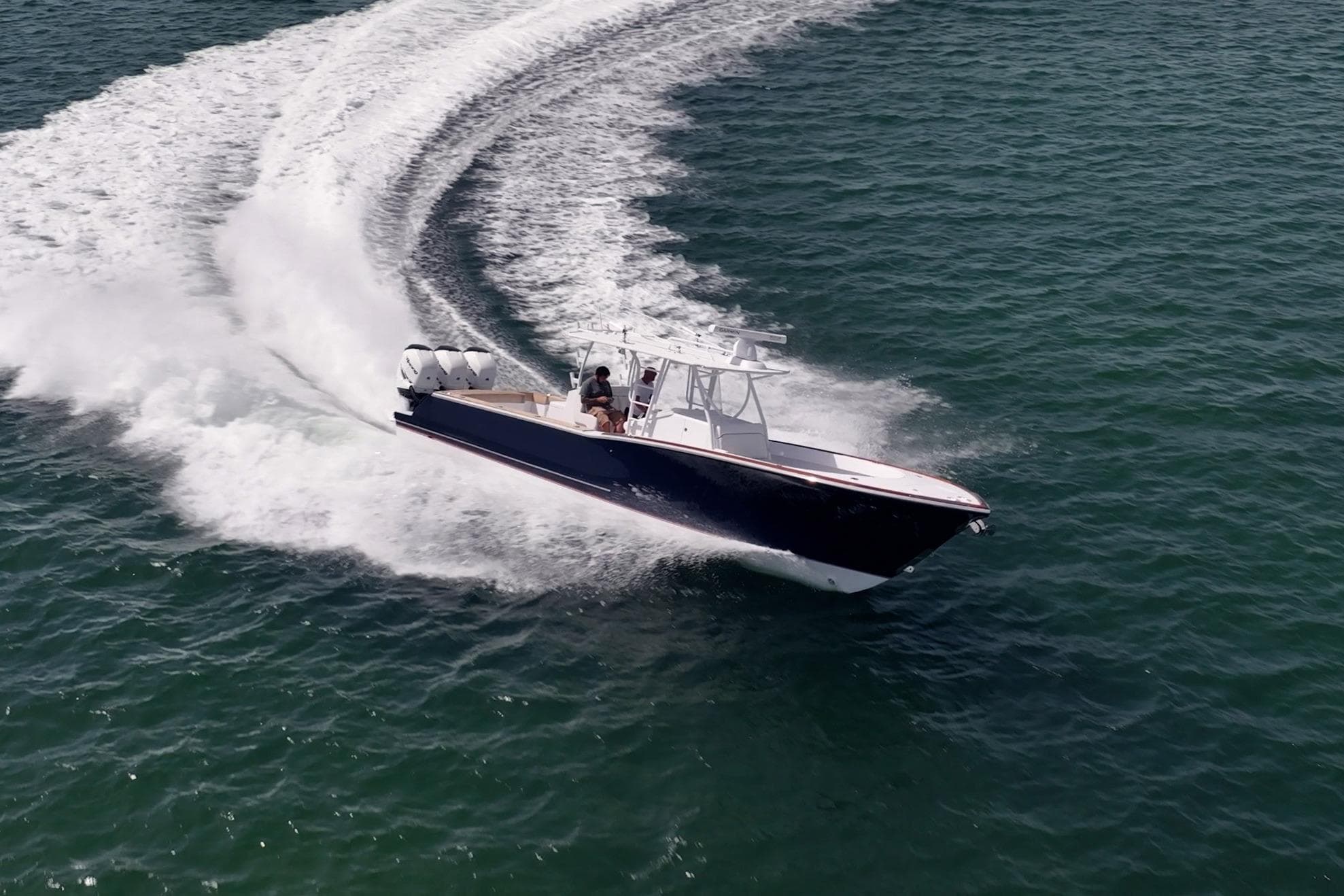 A high-performance center console running on quad outboards